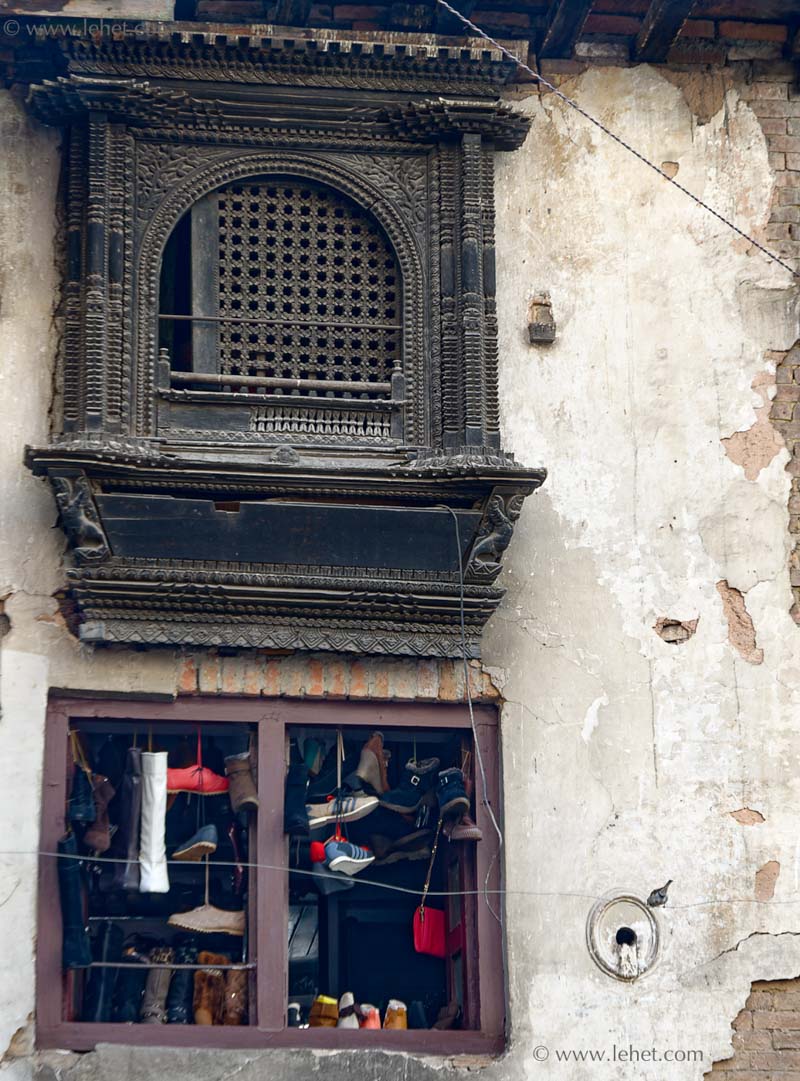 Shoes Hanging in Window Under Carving, Nepal